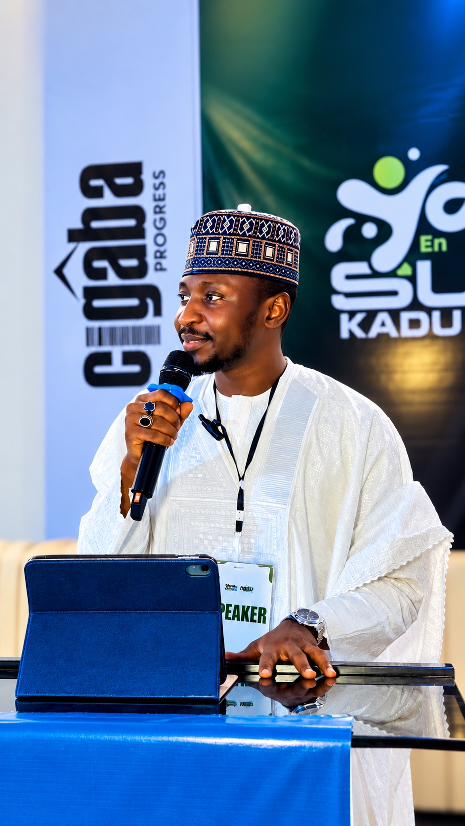 Sir YB speaking into a microphone at the Young Entrepreneurs Summit Kaduna